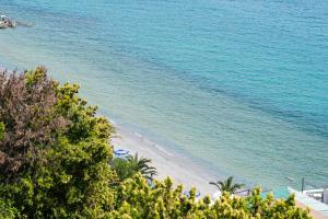 a view of a beach with trees and the ocean at Villa Infinito Blu in Borgio Verezzi