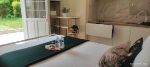 a kitchen with a bed with a tray of food on it at Le CocoOn Doré in Poitiers +20 photos