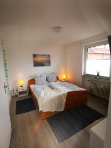 a bedroom with a large wooden bed with two lamps at Seeromantik in Amelinghausen