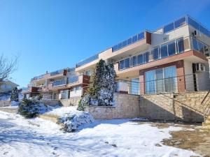 an apartment building with snow on the ground at SKY INFINITY in Balchik
