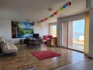 a living room with a table and a dining room at SKY INFINITY in Balchik