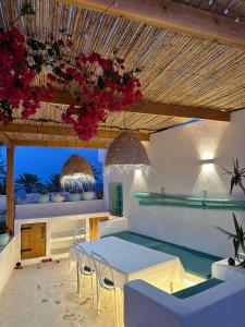 a dining room with a white table and chairs at Dar El Mahdia by Daldoul in Mahdia
