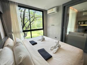a bedroom with a bed with two stuffed animals on it at Deluxe apartment Citygate Condo by Lofty in Kamala Beach +32 photos