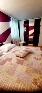a bedroom with a bed with a blanket on it at Apartment near the center - Nada in Malinska