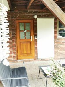 ein Backsteinhaus mit einer Holztür und einem Tisch in der Unterkunft Kleine Auszeit in Amelinghausen