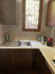 a kitchen counter with a sink and a window at Casa Daniela in Torre delle Stelle