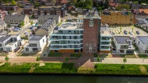 an aerial view of a large building next to the water at B&B Mouttoren Weert in Weert