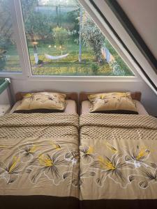 a bed in a room with a large window at Vikendica Živković in Lazarevac