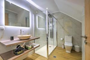 a bathroom with a shower and a sink and a toilet at Gaia Suite in Nafplio +16 photos