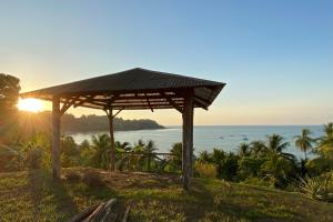 a wooden pavilion with the ocean in the background at Casita Corcovado in Drake