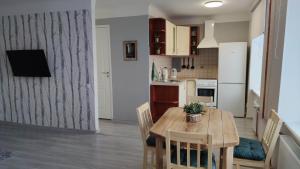 a kitchen and dining room with a table and chairs at Promenade Apartment in Liepāja