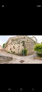 two pictures of a large hill with weeds on it at Appartamento a 200 mt. dal Duomo. CIR: LOTUR31881 in Spoleto