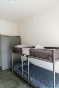 a bunk bed in the corner of a room at IsabellApartments in Canelli