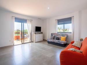 a living room with a couch and a tv at Spacious Holiday Home in Motril with 2 Large Terraces in Motril