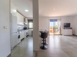 a large white kitchen with a table and a stove at Spacious Holiday Home in Motril with 2 Large Terraces in Motril