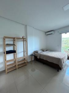 a bedroom with a bed and a ladder and a window at Estadia Wolf Lencois in Lençóis