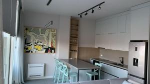 a kitchen with a table and chairs in a room at Green Coast Apartment with Pool in Palasë