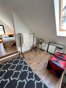 a attic room with a bed and a rug at Guszti Apartman in Pécs +3 photos