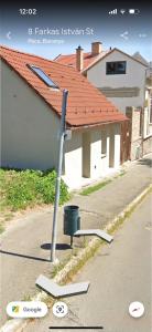 a street sign in front of a house at Guszti Apartman in Pécs