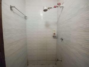 a bathroom with a shower with white tiles at Romantic 1Bedroom Gateway in Kinoo in Kikuyu