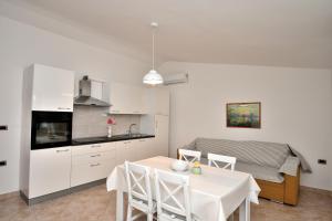 a kitchen and dining room with a table and chairs at House Ariella in Umag
