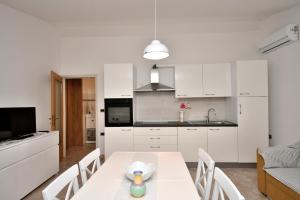 a kitchen and dining room with a table and chairs at House Ariella in Umag