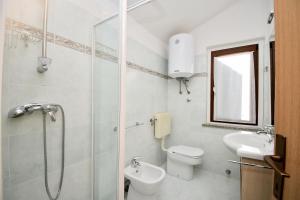 a bathroom with a shower and a toilet and a sink at House Ariella in Umag
