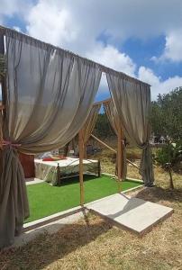 a tent with a bed in a field of grass at Suite under the stars in Kalymnos