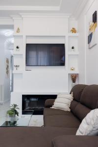 a living room with a couch and a television on a wall at Appartement 3 PIECES NICE Promenade in Nice