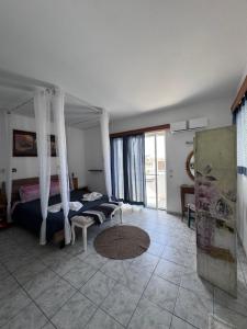 a bedroom with a bed and a room with atained at SunnySun Studios in Faliraki