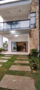 a house with a walkway in front of it at FLECHEIRAS ATLANTICO in Trairi