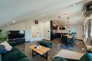 una sala de estar con un sofá y una mesa en Holiday home Magic Sunset, en Imotski