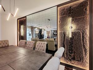 a dining room with a table and chairs at ELAN RIMAL SADAF Suites in Dubai