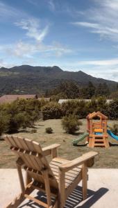 un parque infantil con 2 toboganes y un banco en Casita Boquete, en Boquete