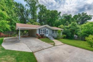a small house with a driveway in a yard at The Creek House in Marietta