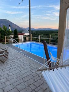 a hammock on a patio next to a swimming pool at VILLA ELLI in Chóïka