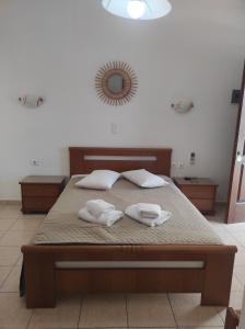 a bedroom with a bed with two towels on it at Vythos in Adamas