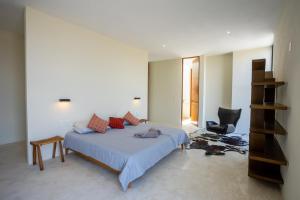 a bedroom with a bed and a desk and a chair at Casona con alberca privada in San Miguel de Allende