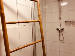 a shower with a wooden ladder in a bathroom at Cologne LUXE Living: Opulent Elegance Unleashed in Cologne