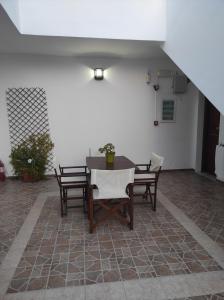 a patio with a table and chairs in a room at Vythos in Adamas