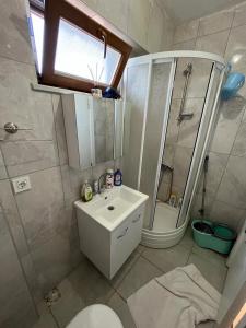 a bathroom with a toilet and a sink and a shower at ERDEK in Erdek