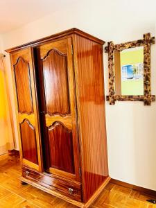 a wooden cabinet is sitting in a room at Casa BB&Djassi in Ponta do Sol