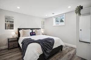 a white bedroom with a large bed and a window at Haven Suite in London, On 2Br, 1Bath with free washer and dryer in London