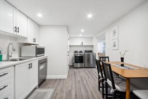a kitchen and dining room with a table and chairs at Haven Suite in London, On 2Br, 1Bath with free washer and dryer in London