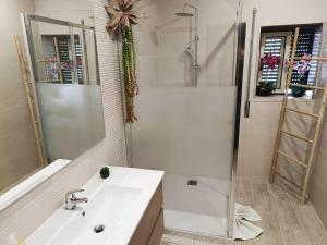 a bathroom with a sink and a shower at Caroça House in Nazaré +17 photos
