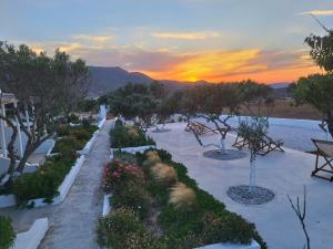 a view of a garden with a sunset in the background at Errika's Sweet Home in Provatas