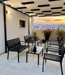 a group of chairs and tables in a room at Pap's Lab Apartments in Heraklio +19 photos