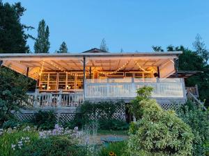 a large building with lights on it in a garden at Shannaghs Sweet Escape in Powell River