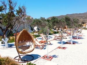 a row of chairs sitting on the beach at Errika's Sweet Home in Provatas