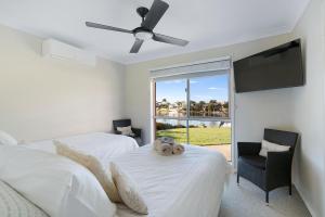 a bedroom with two beds and a flat screen tv at Waterfront BNB in Gold Coast